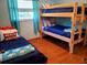 Bright bedroom featuring a bunk bed, a twin bed, and bright blue and red decor at 12361 114Th St, Largo, FL 33778