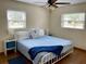 Main bedroom with king-size bed, blue bedding, and wood floors at 12361 114Th St, Largo, FL 33778