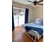 Bedroom with a white metal bed frame, blue bedding, and sliding glass doors at 12361 114Th St, Largo, FL 33778