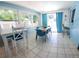 Bright dining room with tile floors, a breakfast bar, dining table, and natural light from surrounding windows at 12361 114Th St, Largo, FL 33778