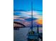 Sailboat by a dock, with a bridge and colorful sunset in the distance at 12361 114Th St, Largo, FL 33778