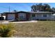 Ranch style home with brick facade, attached garage, and landscaped yard at 12361 114Th St, Largo, FL 33778