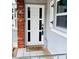 Inviting front door entrance with a white door and brick accents at 12361 114Th St, Largo, FL 33778