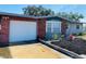 Attached garage with roll-up door and brick exterior at 12361 114Th St, Largo, FL 33778