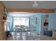 Bright living room with hardwood floors, light blue accents, and a dining area at 12361 114Th St, Largo, FL 33778