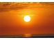 Striking sunset view featuring a bright sun with fiery orange skies and ocean horizon at 12361 114Th St, Largo, FL 33778