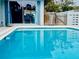 Sparkling clean swimming pool reflecting the surrounding trees and sky at 12361 114Th St, Largo, FL 33778