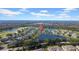 Aerial view of house, community, golf course, and lake at 1252 Lyndhurst Greens Dr, Sun City Center, FL 33573