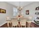 Elegant dining room with hardwood floors, chandelier, and glass table at 1252 Lyndhurst Greens Dr, Sun City Center, FL 33573