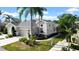 Gray two-story house with a two-car garage and lush landscaping at 1252 Lyndhurst Greens Dr, Sun City Center, FL 33573