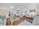 Living room with hardwood floors, light walls and view of kitchen and dining area at 1252 Lyndhurst Greens Dr, Sun City Center, FL 33573