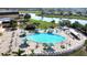 Community pool with plenty of lounge chairs and umbrellas at 1252 Lyndhurst Greens Dr, Sun City Center, FL 33573