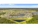 Aerial view of a residential neighborhood with houses and a lake in a lush, green, and picturesque setting at 13182 Twin Bridges Dr, Riverview, FL 33579