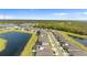 An aerial view of a neighborhood showcasing modern homes lining a street with scenic water views and lush greenery at 13182 Twin Bridges Dr, Riverview, FL 33579