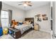 Bedroom with a window, ceiling fan, carpet, and teddy bear at 13182 Twin Bridges Dr, Riverview, FL 33579