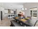 Dining room adjacent to living room and kitchen with wood floors and decor on the walls at 13182 Twin Bridges Dr, Riverview, FL 33579