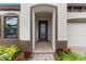 A home's welcoming, covered entryway shows off fresh landscaping and modern design at 13182 Twin Bridges Dr, Riverview, FL 33579