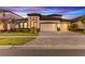 Beautiful single Gathering home with three-car garage and manicured lawn at twilight at 13182 Twin Bridges Dr, Riverview, FL 33579