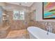 Bathroom with a glass-enclosed shower and a large soaking tub at 13904 Shadow Tree Ln, Tampa, FL 33618