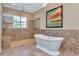 Large bathroom with a freestanding tub and a walk-in shower at 13904 Shadow Tree Ln, Tampa, FL 33618