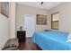 Light and airy bedroom with a light blue bedspread, wood floors and window blinds at 13904 Shadow Tree Ln, Tampa, FL 33618