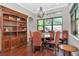 Bright dining room with built-in shelving and hardwood floors at 13904 Shadow Tree Ln, Tampa, FL 33618