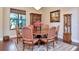 Formal dining room with round table and hardwood floors at 13904 Shadow Tree Ln, Tampa, FL 33618