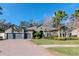 Beautiful two-story home with a three-car garage and lush landscaping at 13904 Shadow Tree Ln, Tampa, FL 33618