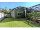 Green house with backyard, pool, and lush landscaping at 13904 Shadow Tree Ln, Tampa, FL 33618