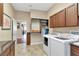 Laundry room with washer, dryer, and built-in shelving at 13904 Shadow Tree Ln, Tampa, FL 33618