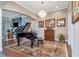 Spacious living room featuring a grand piano and hardwood floors at 13904 Shadow Tree Ln, Tampa, FL 33618