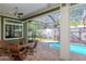 Relaxing poolside patio with seating and dining area at 13904 Shadow Tree Ln, Tampa, FL 33618