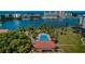 Aerial view showing waterfront property with a community pool at 14993 Imperial Point N Dr, Largo, FL 33774