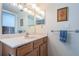 Bathroom with vanity, sink, and linen storage at 14993 Imperial Point N Dr, Largo, FL 33774