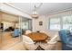 Bright dining room with octagonal table and chairs, near sliding doors to a patio at 14993 Imperial Point N Dr, Largo, FL 33774