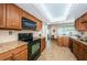 Updated kitchen featuring granite counters, dark cabinetry, and black appliances at 14993 Imperial Point N Dr, Largo, FL 33774