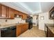 Modern kitchen with granite countertops, dark wood cabinets, and a tile floor at 14993 Imperial Point N Dr, Largo, FL 33774