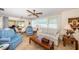 Cozy living room with tiled floors, comfy seating, and a ceiling fan at 14993 Imperial Point N Dr, Largo, FL 33774