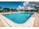 Community pool with adjacent patio and grilling area at 14993 Imperial Point N Dr, Largo, FL 33774