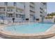 Refreshing community pool with surrounding patio at 17980 Gulf Blvd # 403, Redington Shores, FL 33708