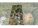 A stunning aerial view showcasing the property's generous lot size and lush surrounding landscape at 18026 Macy Rd, Weeki Wachee, FL 34614