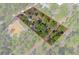 A stunning aerial view showcasing the property's generous lot size and lush surrounding landscape at 18026 Macy Rd, Weeki Wachee, FL 34614