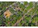 An aerial shot showcases the property's wooded surroundings and proximity to neighboring homes at 18026 Macy Rd, Weeki Wachee, FL 34614