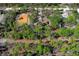 This aerial view highlights a wooded lot with the property nestled among mature trees at 18026 Macy Rd, Weeki Wachee, FL 34614