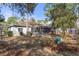 Picturesque backyard with a screened-in patio, vibrant garden, and a charming home exterior at 18026 Macy Rd, Weeki Wachee, FL 34614