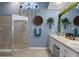 Charming bathroom featuring double sinks, decorative mirror and hanging decorative plants at 18026 Macy Rd, Weeki Wachee, FL 34614