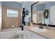 Bathroom featuring tile bathtub, sink, and decorative wreath at 18026 Macy Rd, Weeki Wachee, FL 34614