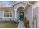 Close-up of the home's entrance, featuring a decorative door, well-tended landscaping, and inviting walkway at 18026 Macy Rd, Weeki Wachee, FL 34614