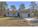 Charming one-story home featuring a well-maintained lawn, attached garage, and welcoming front entrance at 18026 Macy Rd, Weeki Wachee, FL 34614