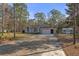 Charming one-story home featuring a well-maintained lawn, attached garage, and welcoming front entrance at 18026 Macy Rd, Weeki Wachee, FL 34614